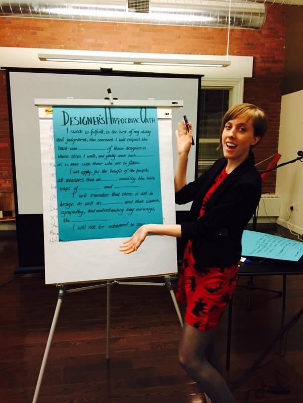 Samantha Dempsey poses with a "fill-in-the-blanks" template of the Designer's Oath