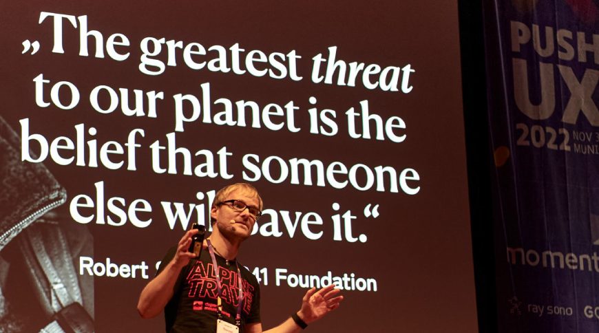 Thorsten Jonas, SUX Network founder, on stage at PUSH UX 2022, championing sustainable UX.