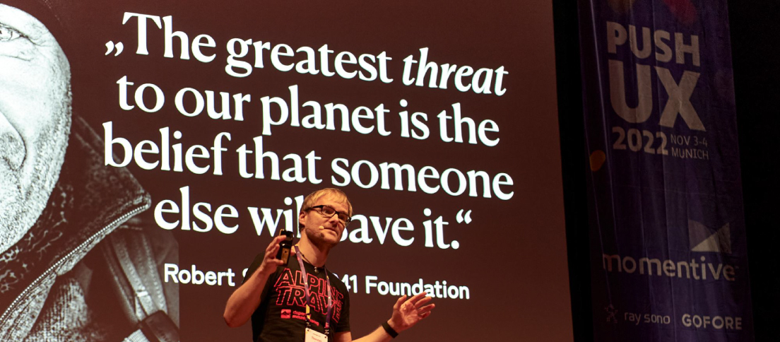 Thorsten Jonas, SUX Network founder, on stage at PUSH UX 2022, championing sustainable UX.